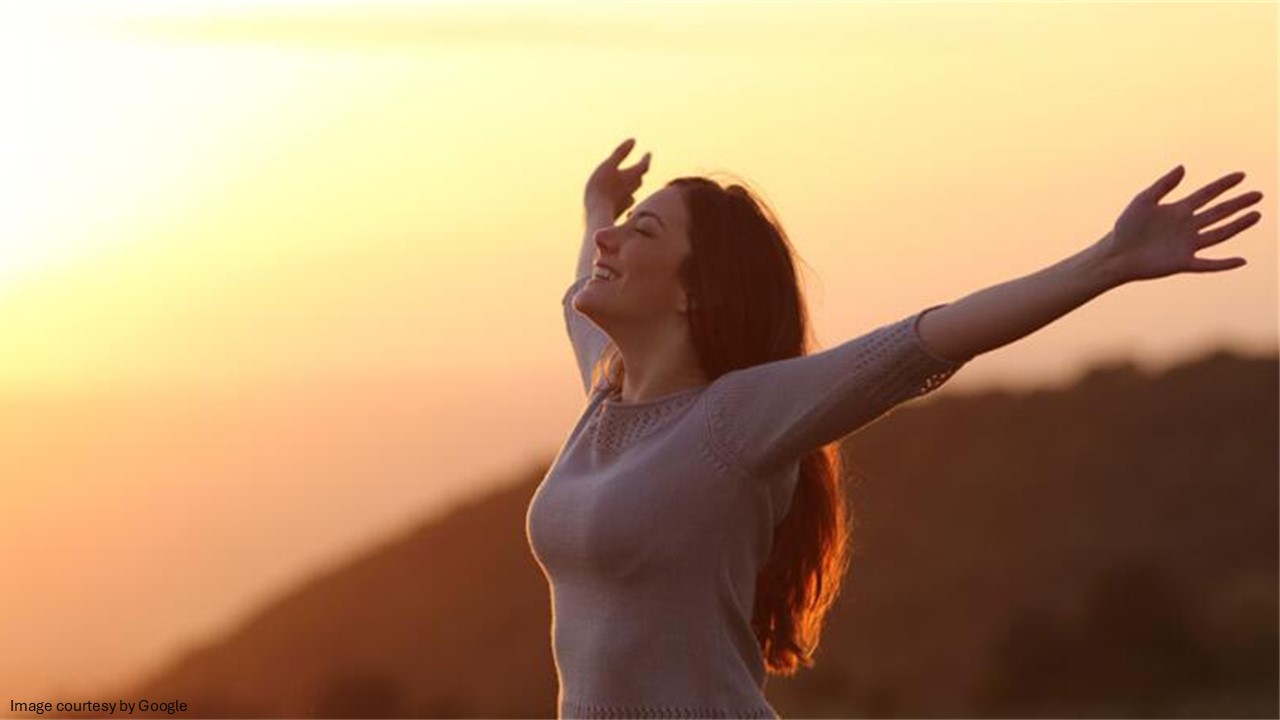 Girl with open hands on the hill
