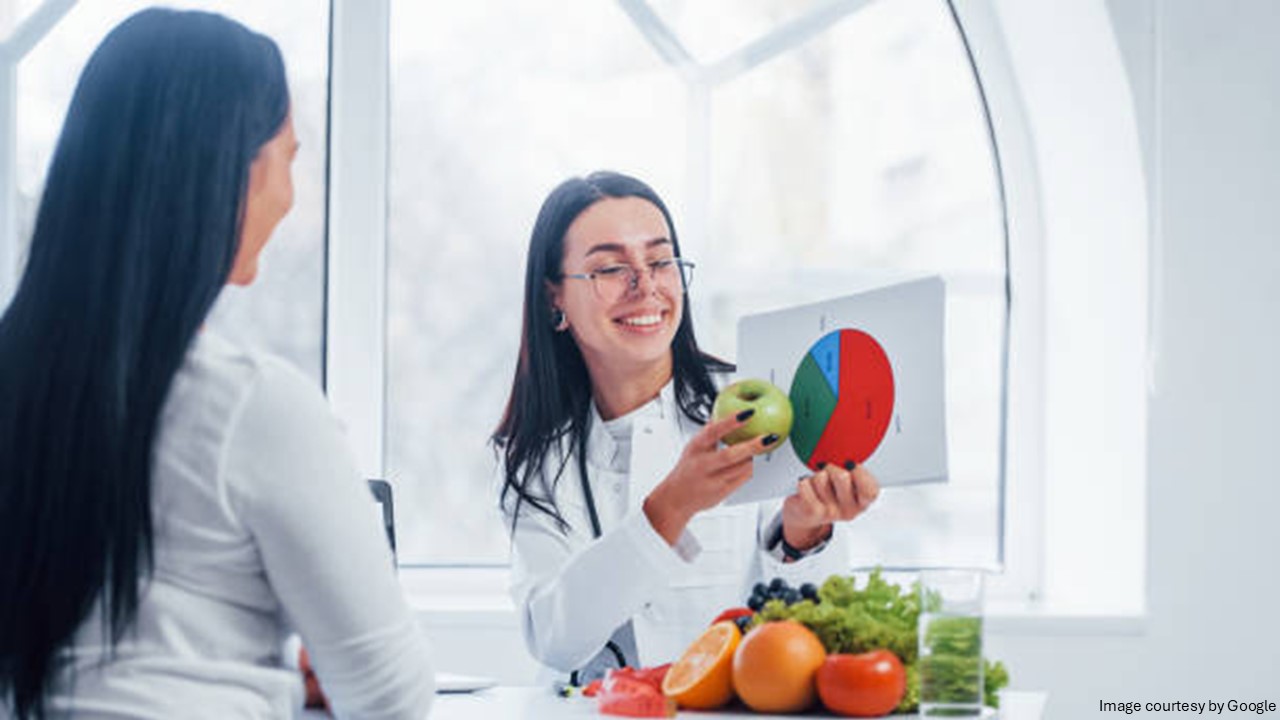 A girl showing chart with fruits around her