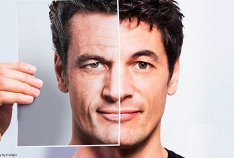 A person holding a sheet showing before and after skin aging