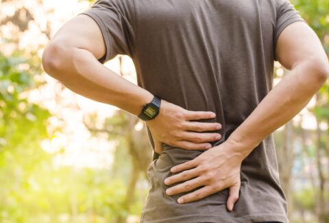 Person Experiencing Lower Back Pain