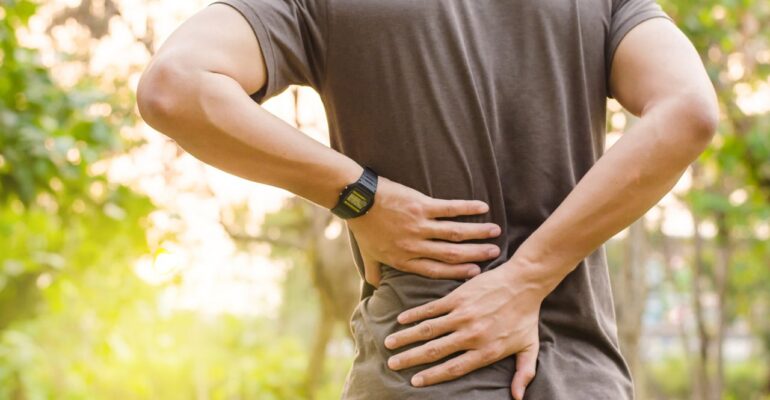 Person Experiencing Lower Back Pain