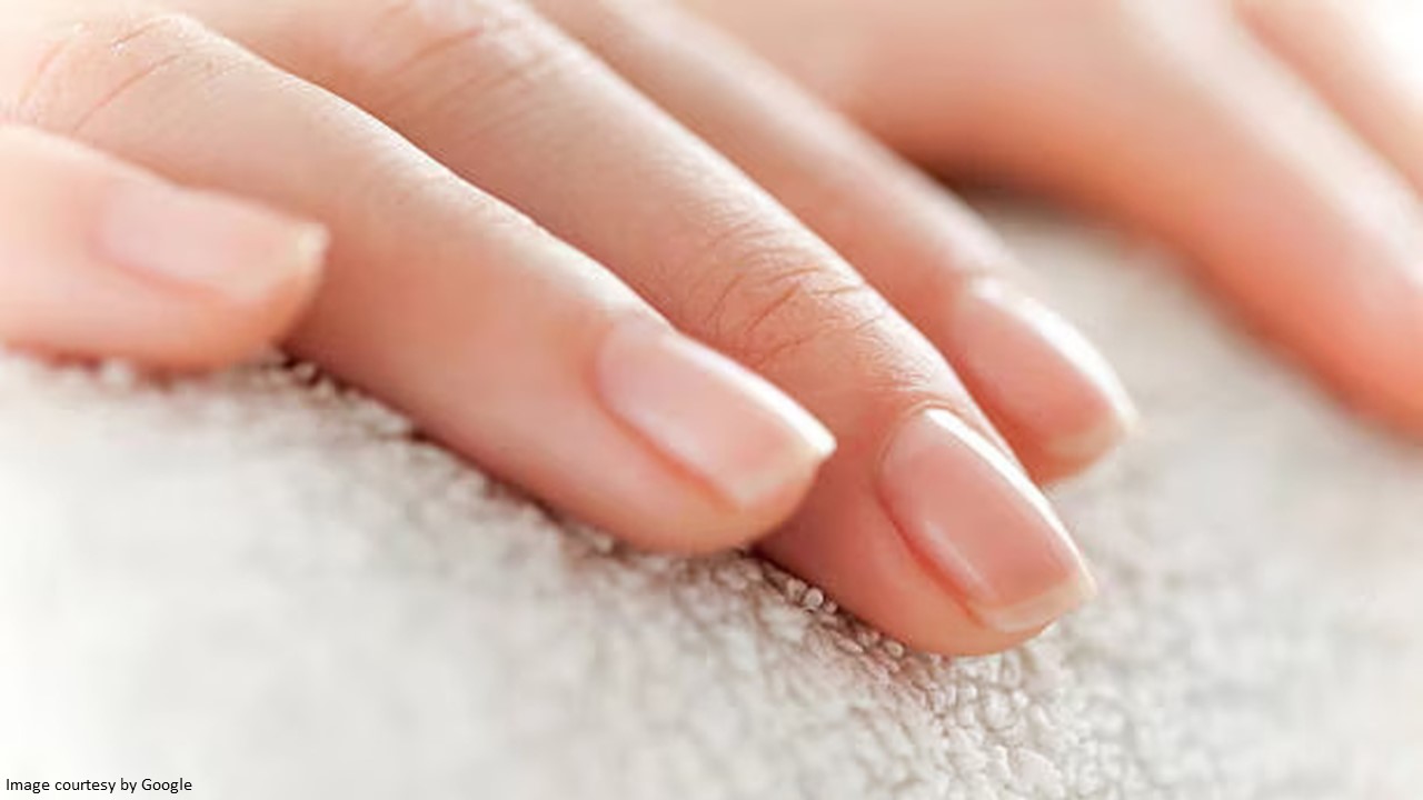 A close-up view of healthy, well-maintained fingernails with tips on how to grow nails fast.