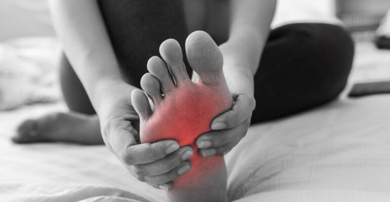 Image of Leg and Foot Cramps at Night: A person experiencing nighttime leg and foot cramps, characterized by involuntary muscle contractions causing discomfort during sleep.