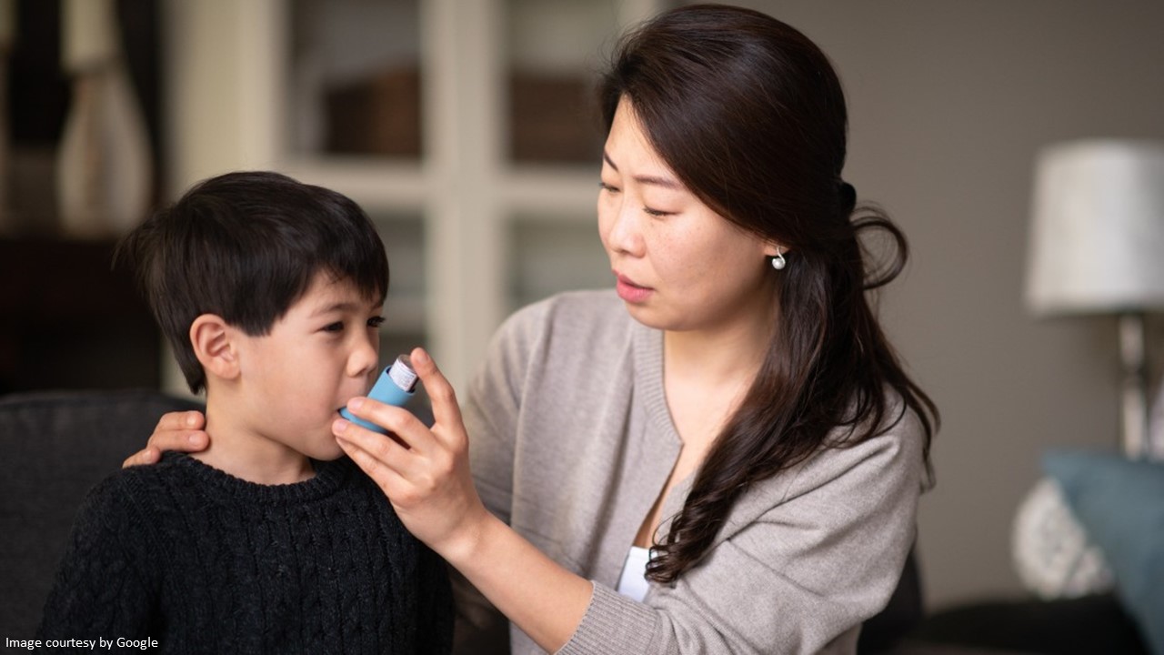 Image of a small boy demonstrating asthma control by using an inhaler with proper technique.