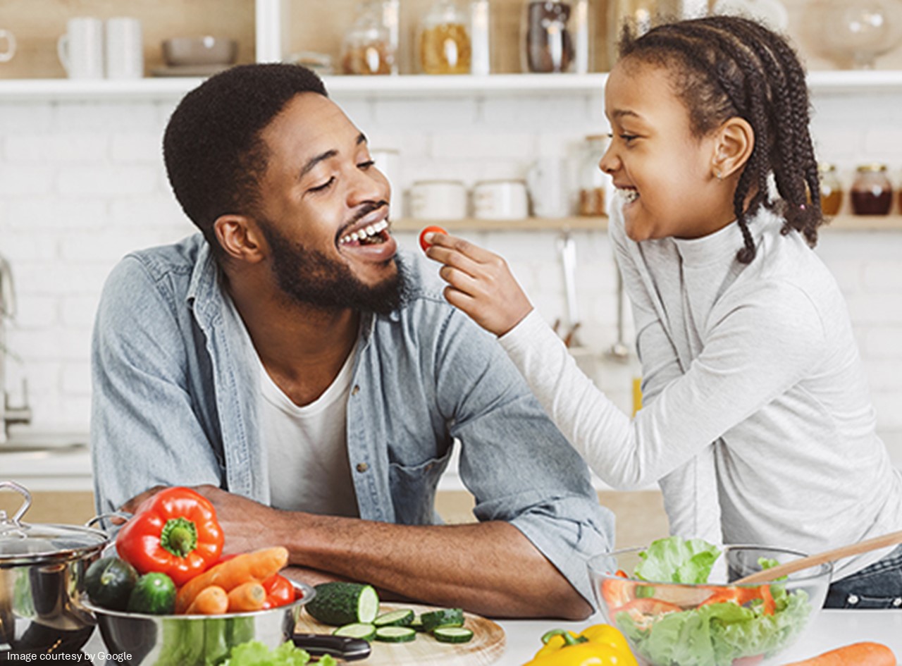 A person eating food from a child hands