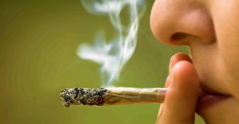 "Image of a woman smoking, a risk factor for high blood pressure.
