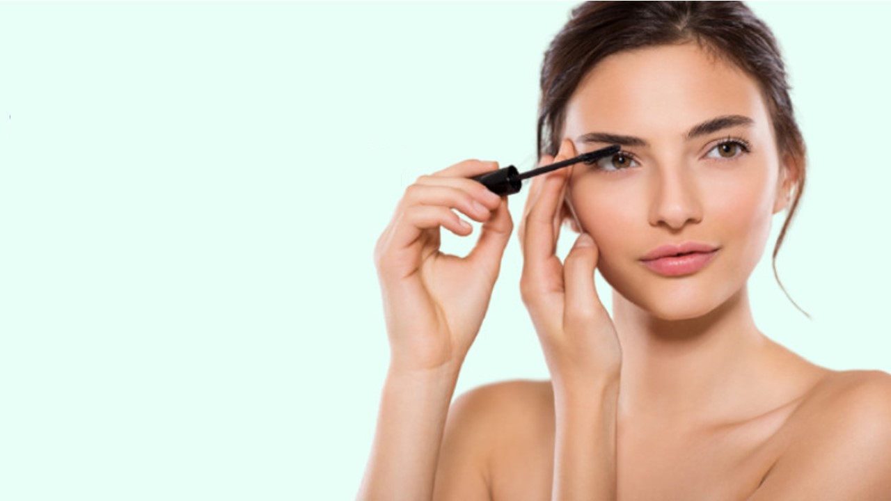 Woman applying Careprost eye drops for enhanced eyelash growth and eye care.