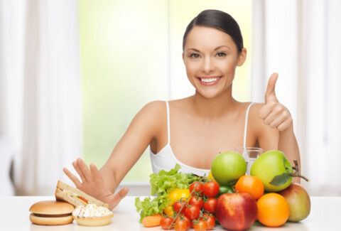 woman with fruits rejecting junk food
