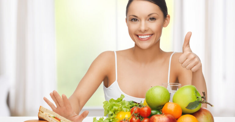 woman with fruits rejecting junk food