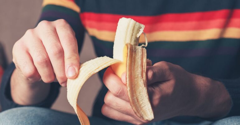Person enjoying a ripe banana.