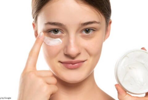 Girl applying eye care products