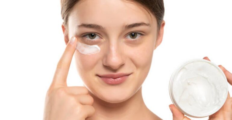 Girl applying eye care products