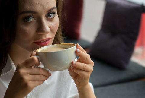 A steaming cup of coffee, perfectly brewed, accompanied by a gentle wisp of rising steam.