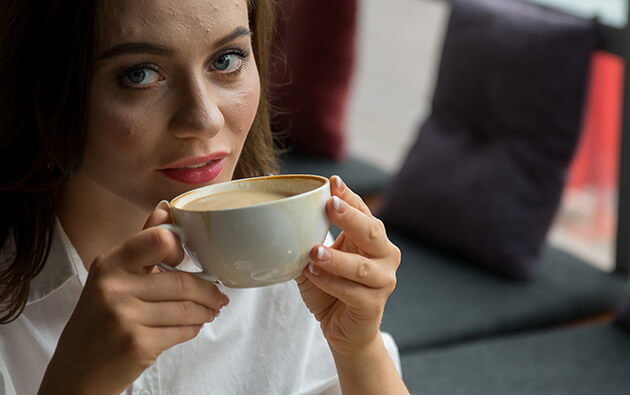 A steaming cup of coffee, perfectly brewed, accompanied by a gentle wisp of rising steam.
