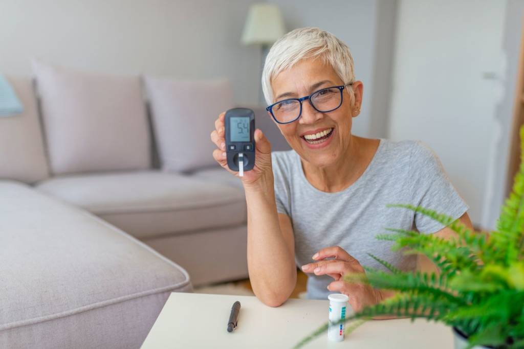 Image of a middle-aged woman checking her blood sugar level with a glucometer