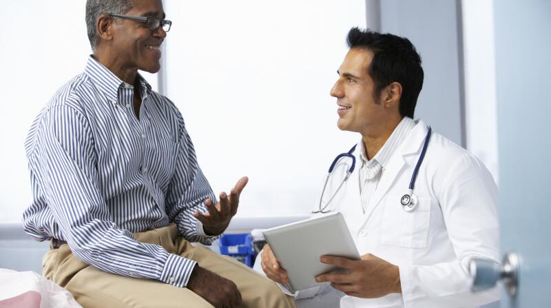 Medical screenings: Doctor checking patient's blood pressure during a routine physical exam.
