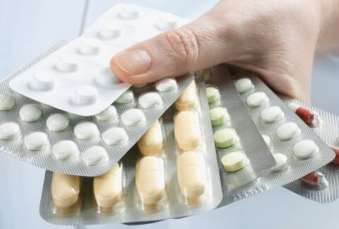 A group of pharmaceutical pills arranged in a circular pattern, symbolizing the topic of alpha blockers and their applications in medicine.