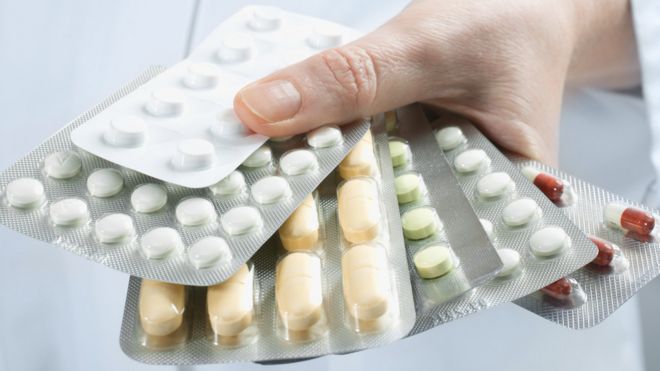 A group of pharmaceutical pills arranged in a circular pattern, symbolizing the topic of alpha blockers and their applications in medicine.