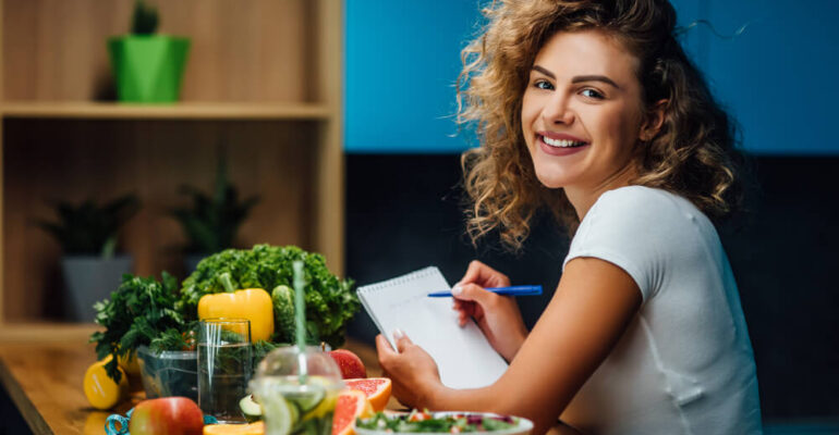 Women sitting and enjoying nutritious meal while discussing nutrition tips for women's health