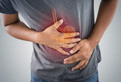 Person standing with acid reducers: Illustration showcasing PPIs, H2 blockers, and healthy digestion.