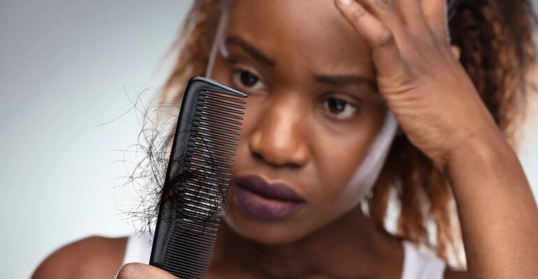 Women looking at her hair which are there in the comb