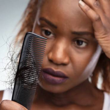 How does stress contribute to hair loss?
