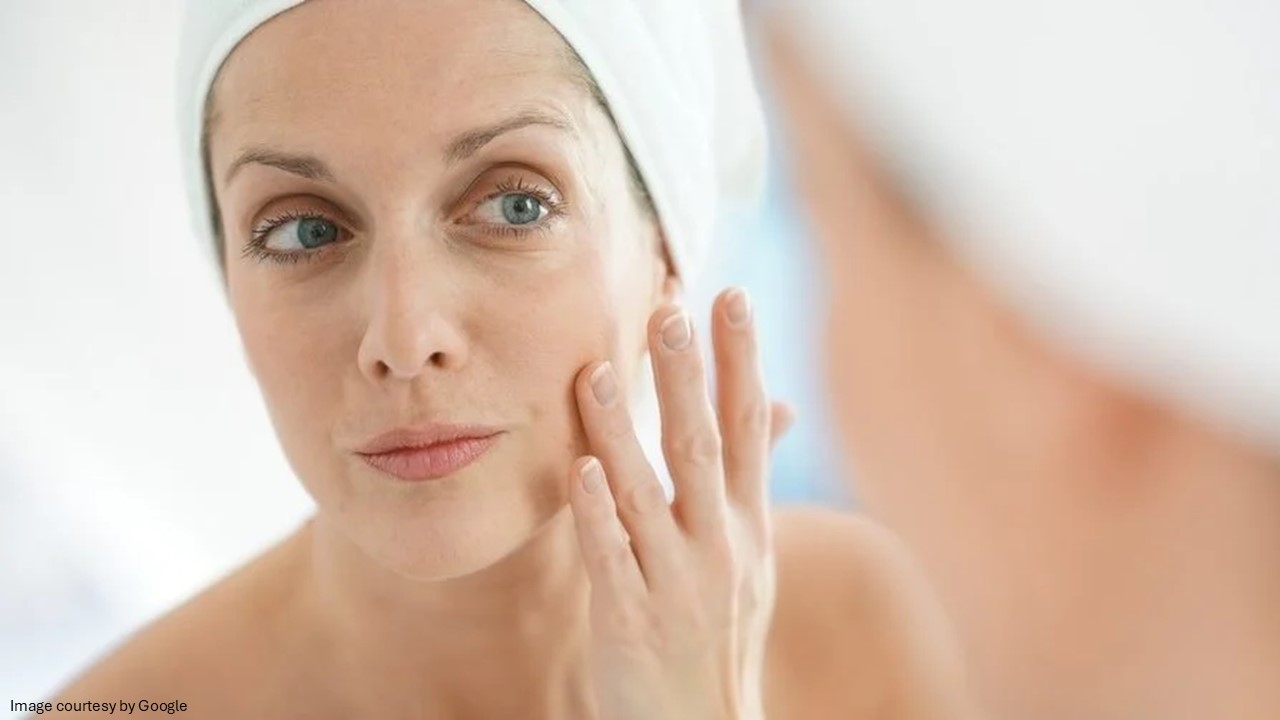 A girl touching face and looking herself in the mirror