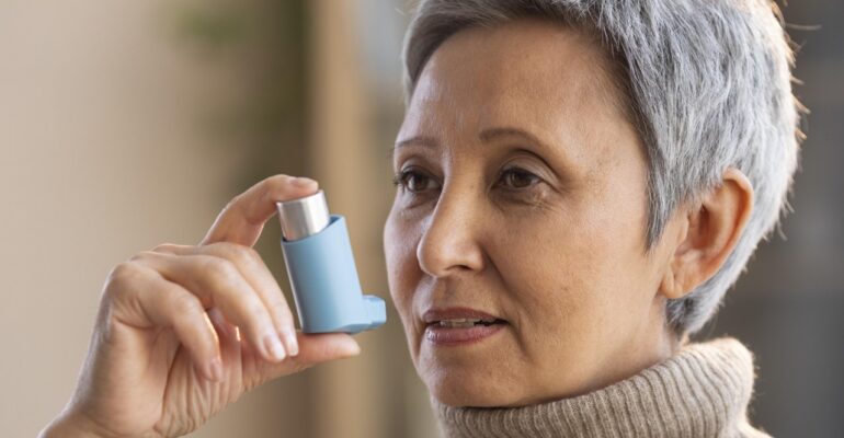 A lady using asthma inhalers