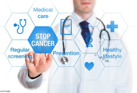 Doctor clicking stop cancer button
