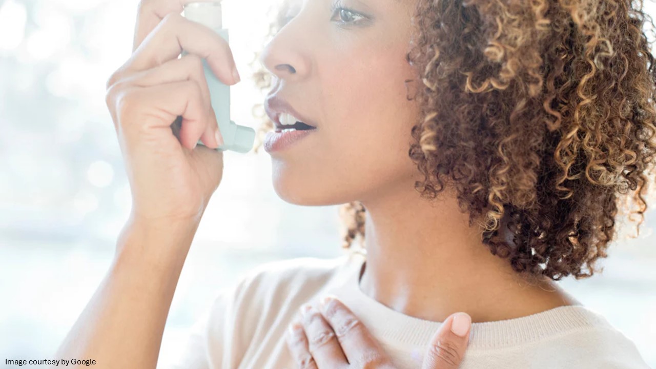 A lady using asthma inhaler