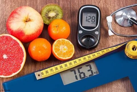 table with fruit, diabetes monitor & weight scale