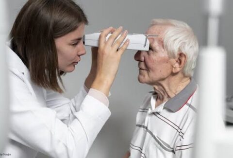 doctor checking eyes of patient