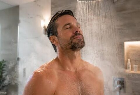 man taking shower in hot bath