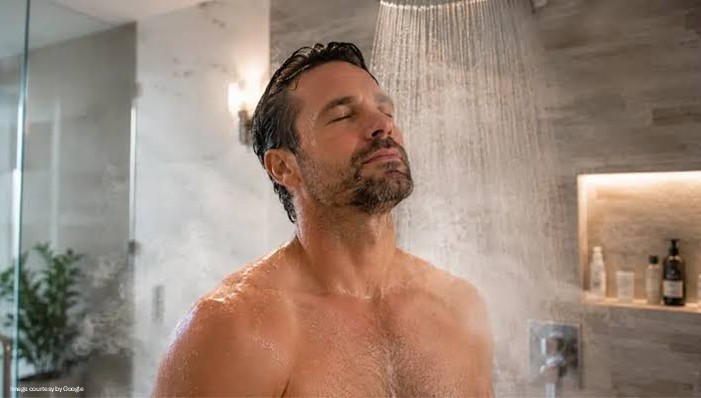 man taking shower in hot bath